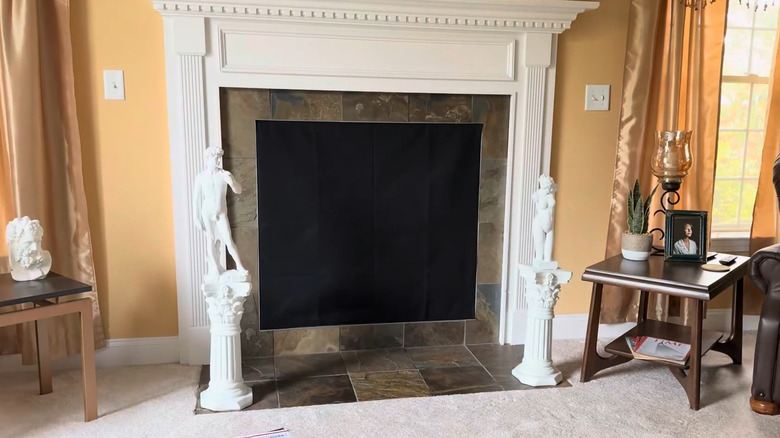 Fireplace covered with a black fireplace blanket