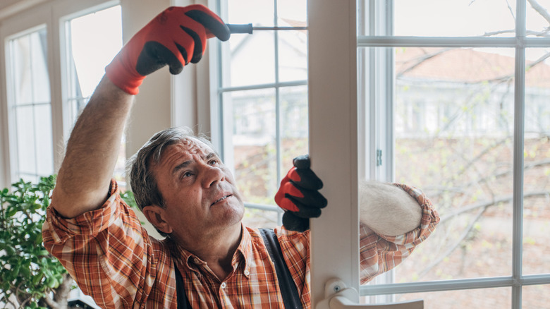 A man working on installing a patio door