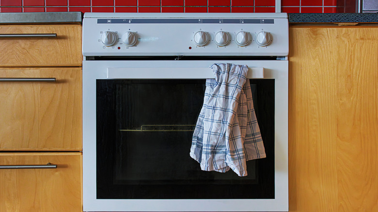 kitchen towel hanging from a white oven