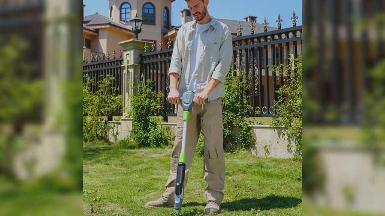 a person using the DIAINSKY electric weed puller to pull out weeds in a lawn