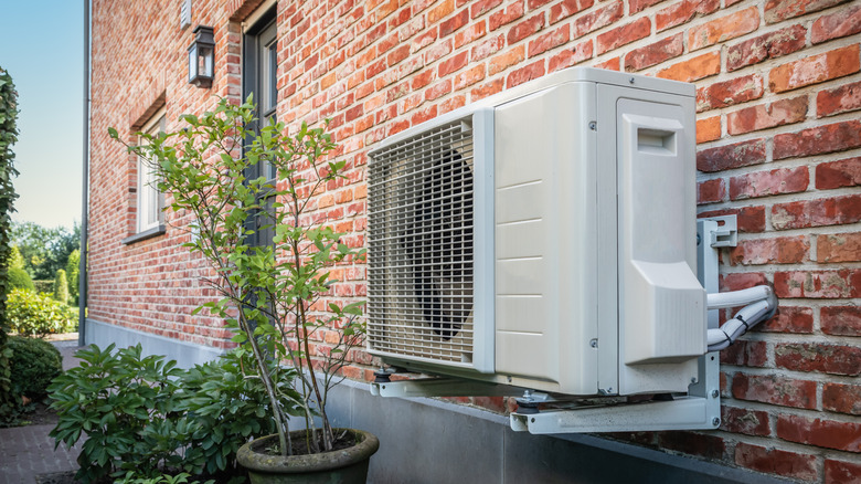 An air conditioner condenser unit mounted on an exterior wall