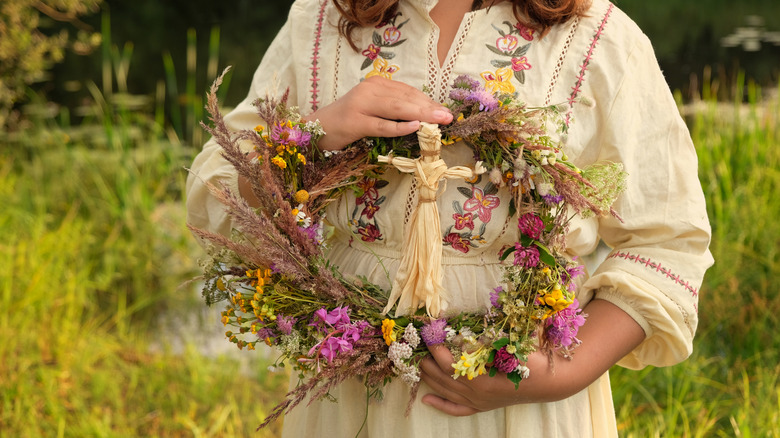 Close up of a wreath with corn husk doll