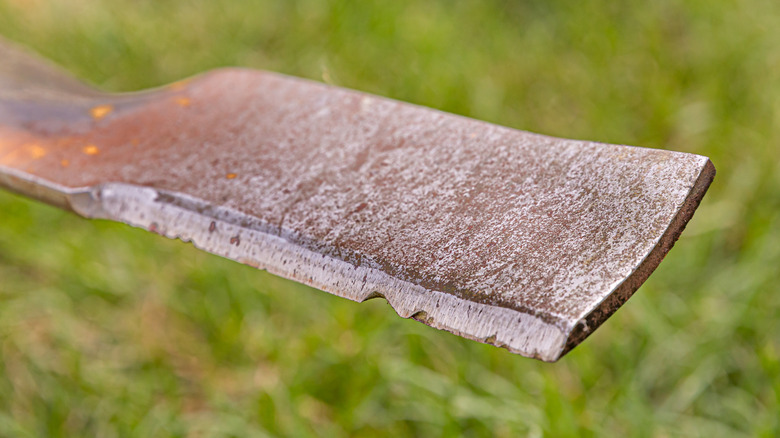 An old and worn out lawn mower blade