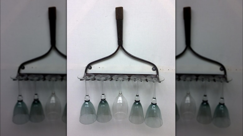 An old rake head repurposed as a holder for wine glasses