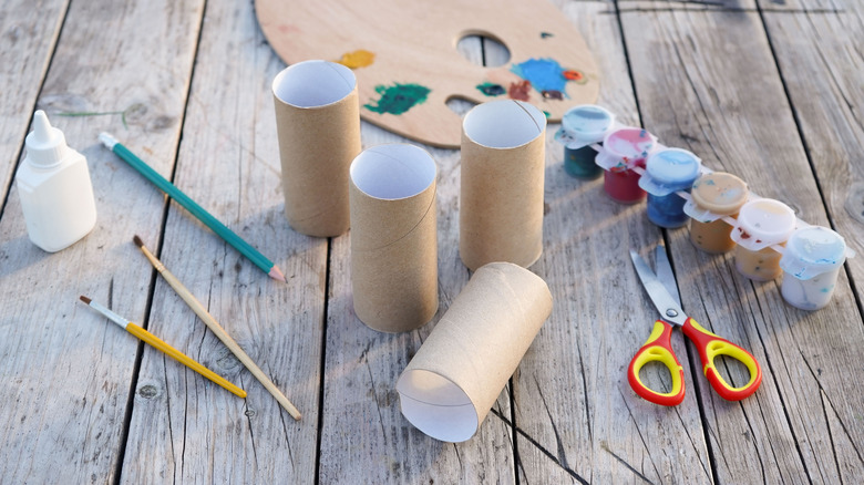 Rolls of empty toilet paper tubes on a craft table