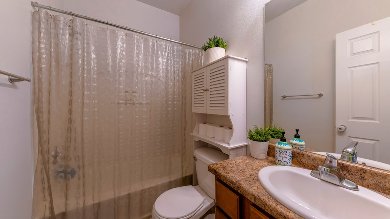 Bathroom with plastic shower curtain