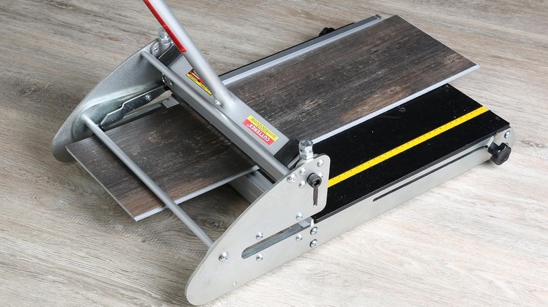 Dark wood vinyl plank on aluminum steel flooring cutter