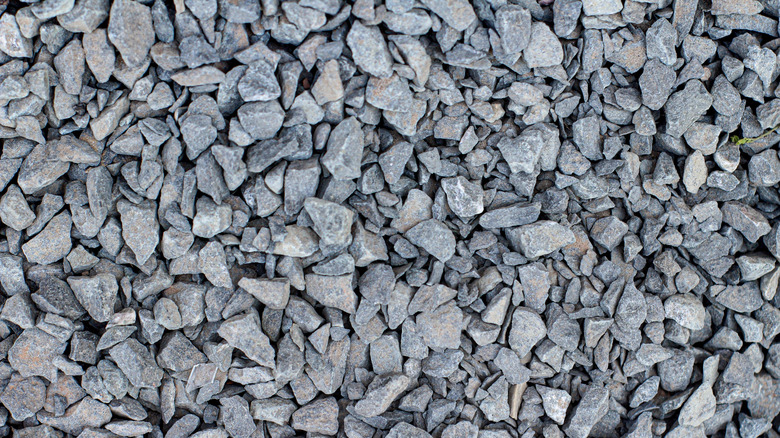 Grey crushed rock, angular gravel.