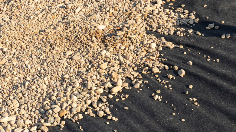 Gravel laid on top of landscaping fabric.