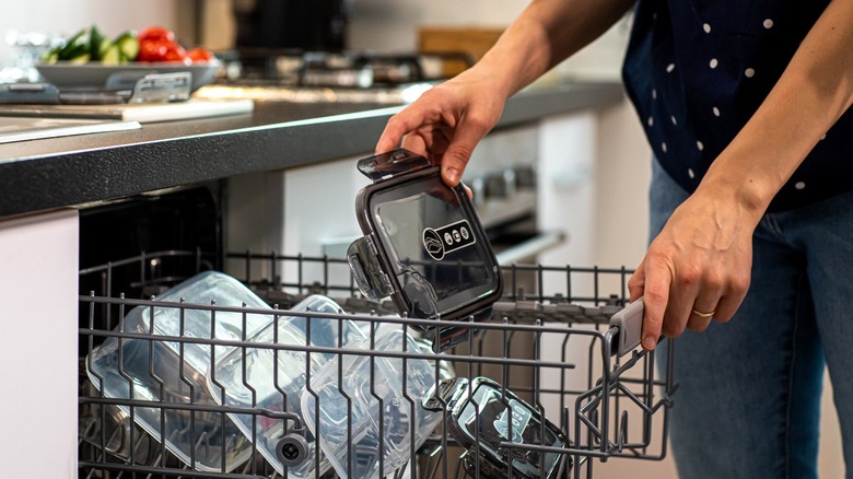 woman putting plastic in dishwasher