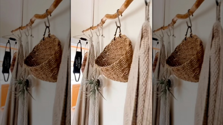 Suspended tree branch bathroom towel rack