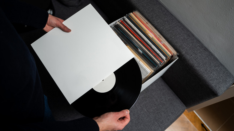 Person sorting through their collection of vinyl records