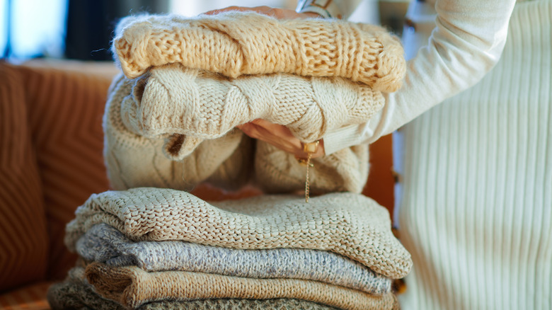 woman with folded sweaters