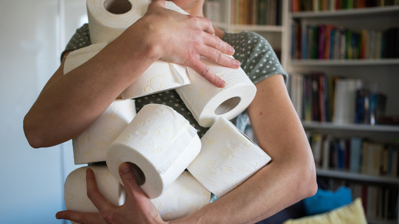 person holding toilet paper