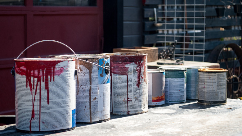 paint cans in front of garage