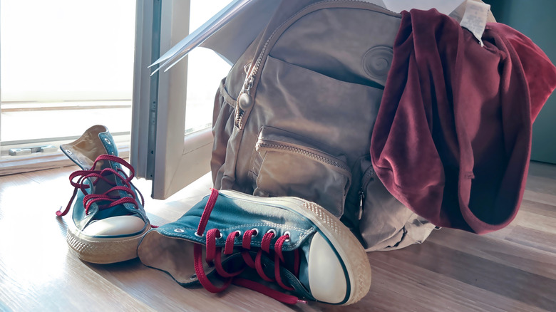 Backpack and shoes left on floor by front door