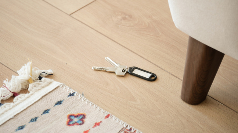 Pair of keys left on floor near rug