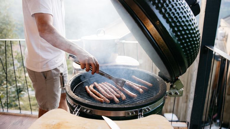 Close up of man grilling on balcony