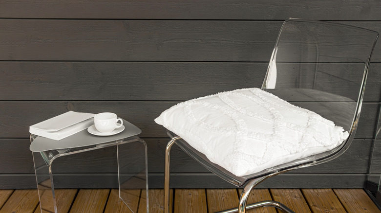 Close up of chair with pillow and book on side table
