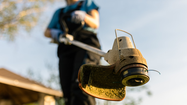 Person holding string trimmer