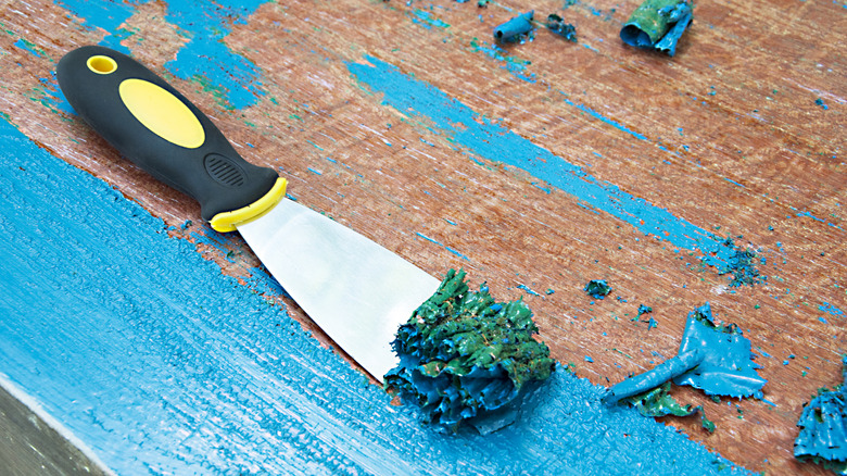Putty knife used to scrape up layers of paint.
