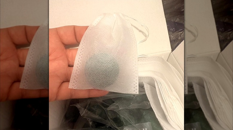 close-up of a ROTIAH repellent tablet in its mesh bag