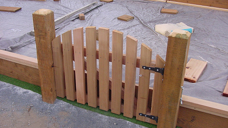 Wooden gate attached to a short fence