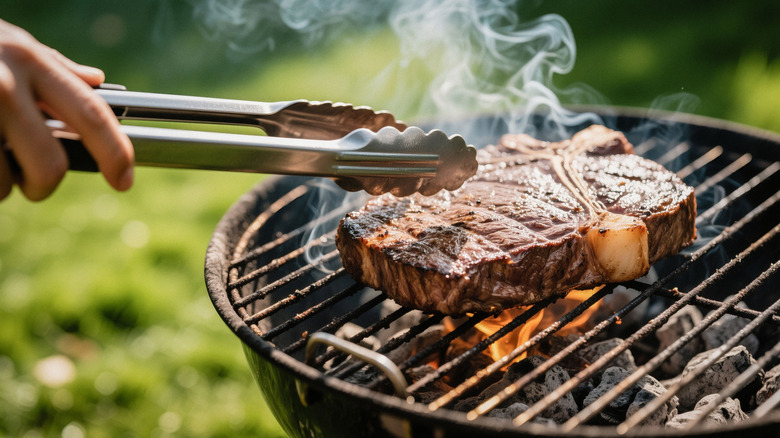 Juicy steak being cooked on a charcoal grill