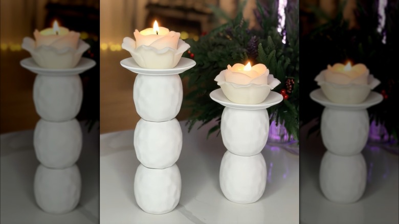A DIY pillar candle holder made using a plate and vases from Dollar Tree.