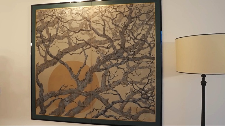 A Japanese screen hangs on the wall, framed as art.