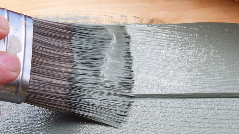 decorators paintbrush with blue gray paint
