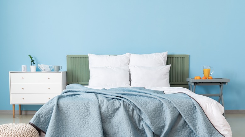 bedroom with light blue walls and white pillows