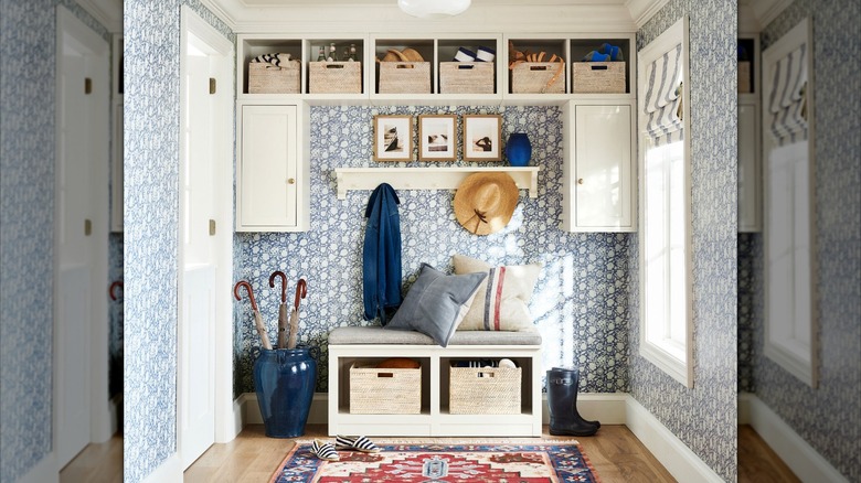 Mudroom with patterned blue wallpaper