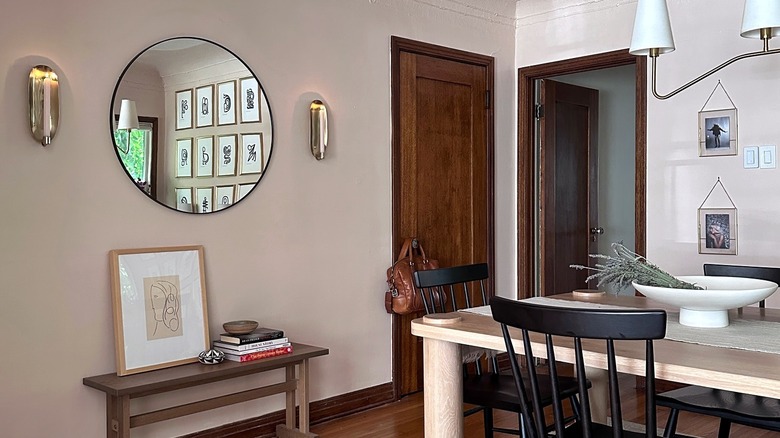A black circular IKEA mirror in a dining room