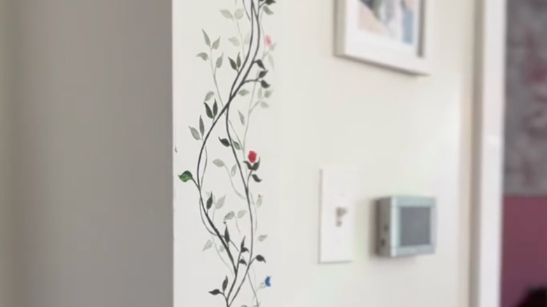 Height chart painted over with a flowery vine