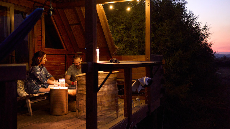 couple hanging out on a patio in the evening