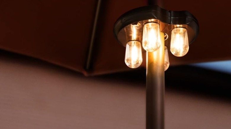 Close-up of the Nora-Gift patio umbrella lights under a brown umbrella