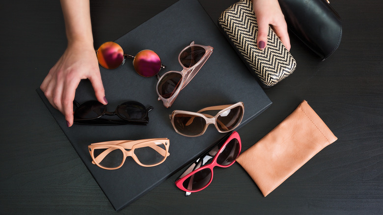 hands sorting through sunglasses