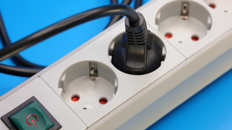Black plug plugged into a surge protector