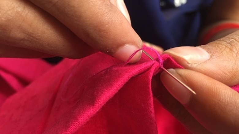 Closeup of sewing red cloth