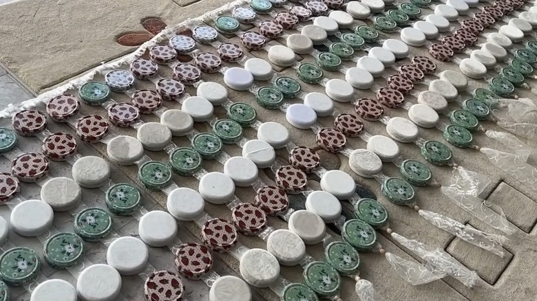 Curtains made of jar lids before being hung