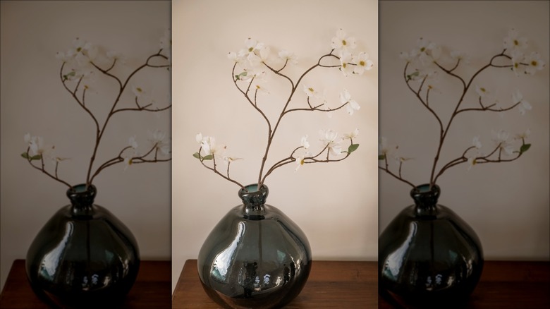 Artificial plant stems in a glass vase