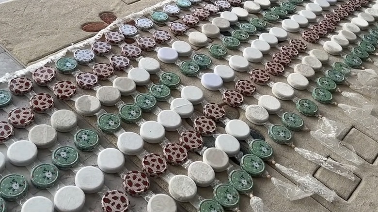 Curtains made of jar lids before being hung
