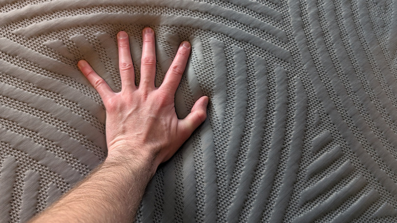 Man's hand feeling grey CoolNest Mattress