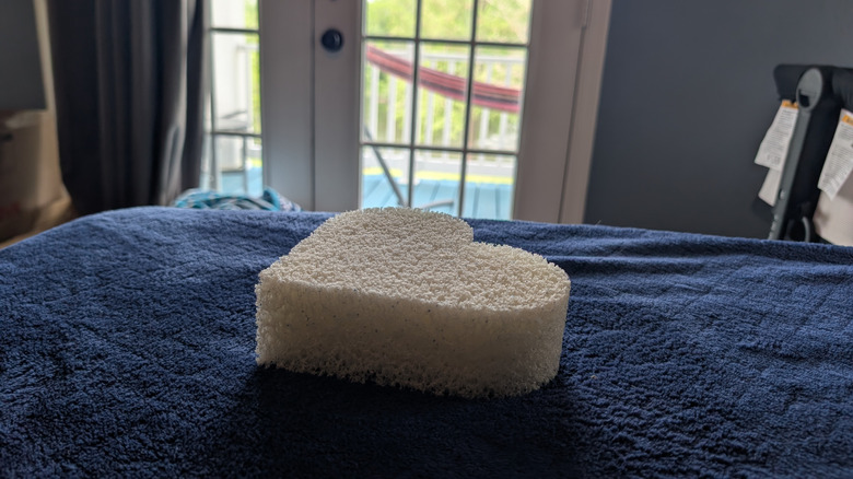 Mattress memory foam cut into the shape of a heart lying on blue blanket
