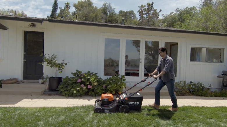 Man pushing Atlas lawn mower