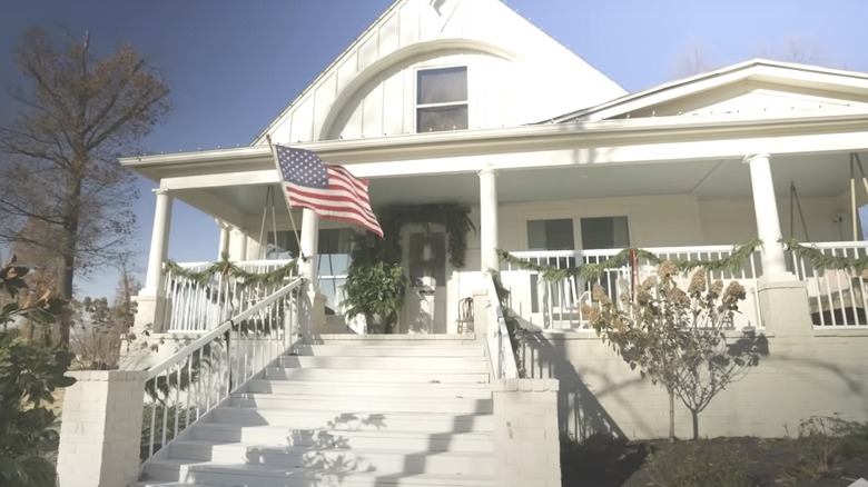 White farm house porch with American flag
