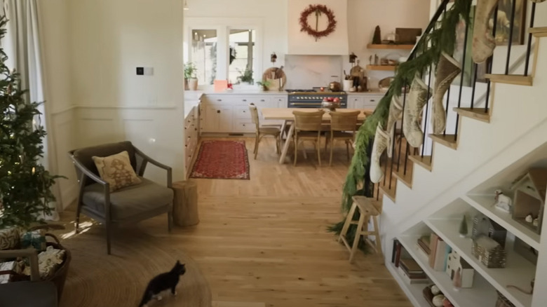 open shelving under white stairs