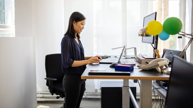 person working at standing desk