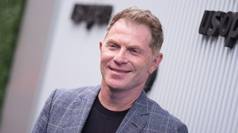 Bobby Flay posing on red carpet